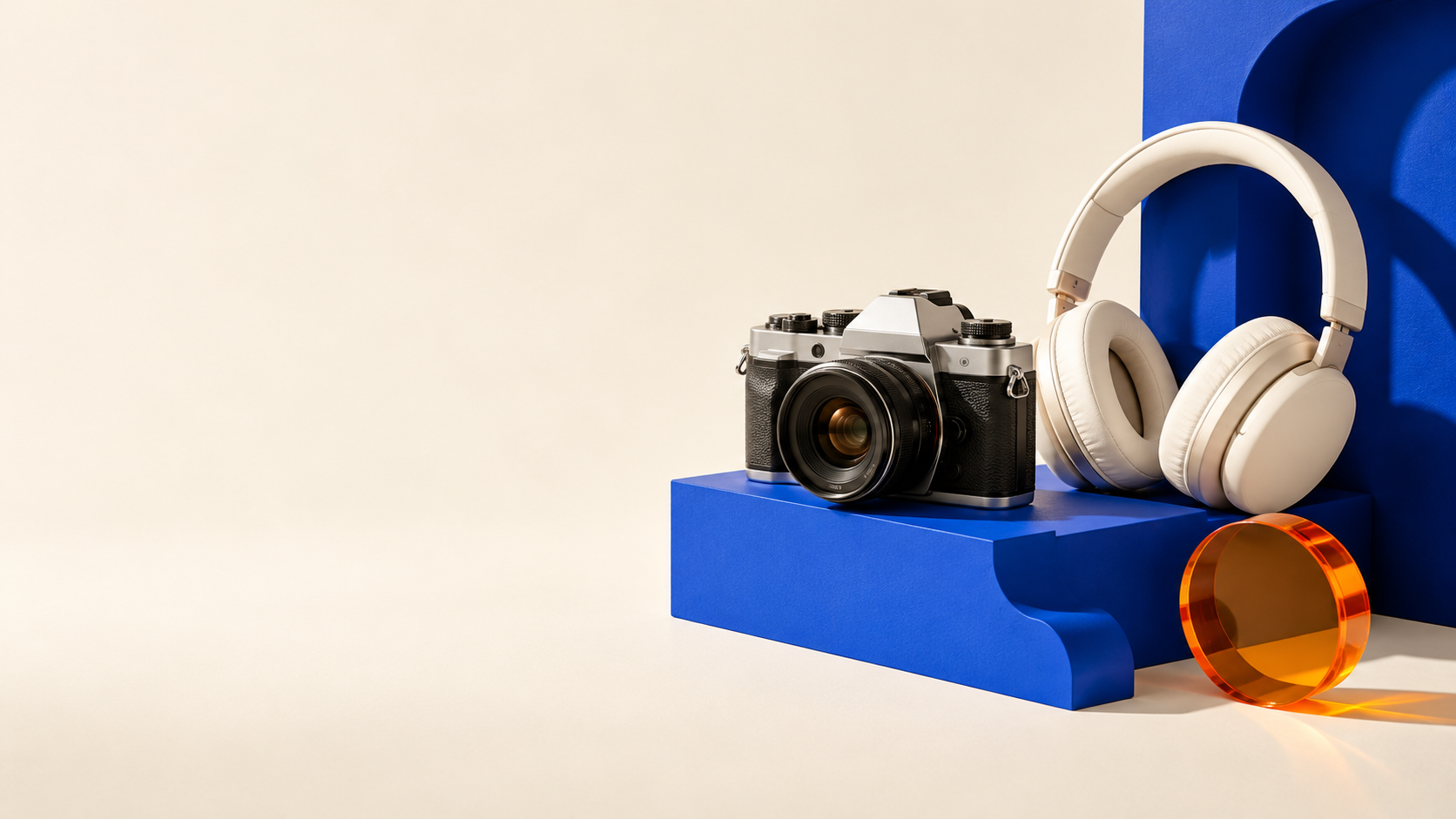 Illustrative camera and headphones on cobalt blue display blocks